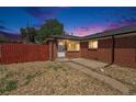 Charming brick home with a well-kept yard and a cozy front porch at 3581 Olive St, Denver, CO 80207