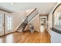Grand entryway with hardwood floors, staircase, and decorative sculpture feature for a stylish home welcome at 3842 S Quebec St, Denver, CO 80237
