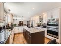 Well-equipped kitchen with a large island, stainless steel appliances, and plenty of counter space at 3842 S Quebec St, Denver, CO 80237