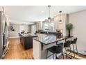 Modern kitchen with sleek countertops, stainless steel appliances, and a breakfast bar for casual dining at 3842 S Quebec St, Denver, CO 80237