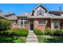 Attractive townhome featuring brick accents, a covered entry, and well-maintained landscaping at 8105 E Bayaud Ave, Denver, CO 80230