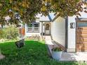 Inviting front yard with lush green grass, a charming tree swing, and a beautifully landscaped entrance at 3835 Shefield Dr, Broomfield, CO 80020