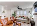 Bright and open living room boasts stylish furniture, hardwood floors, and plentiful natural light at 21418 E Stroll Ave, Parker, CO 80138