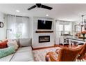 Comfortable living area with modern fireplace, TV, hardwood flooring, and neutral color palette at 21418 E Stroll Ave, Parker, CO 80138