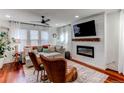 Inviting living space showcases a cozy seating arrangement, chic fireplace, and hardwood floors at 21418 E Stroll Ave, Parker, CO 80138