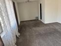 Spacious living room features new carpet, fresh paint, and bright, natural light at 2302 S Raleigh St, Denver, CO 80219