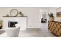 Living room featuring wood floors, fireplace, and modern decor at 3540 Everett St, Wheat Ridge, CO 80033