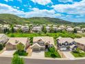 A high angle of several two story homes in a community with green spaces and rolling hills in the background at 5010 Persimmon Ln, Castle Rock, CO 80109