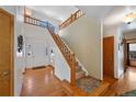 Spacious foyer with hardwood floors and a staircase leading to the upper level at 8441 Urban Ct, Arvada, CO 80005