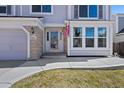 Inviting front entrance with brick accents and a well-lit pathway at 8441 Urban Ct, Arvada, CO 80005