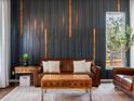 Stylish living room with dark accent wall, modern decor, and a cozy leather sofa at 3043 W 109Th Pl, Westminster, CO 80031