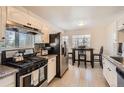 Well-equipped kitchen with modern appliances and a breakfast nook with seating at 5295 Perry St, Denver, CO 80212