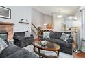 Comfortable living room features a brick fireplace, high ceilings, and an open floor plan at 13040 W 63Rd Pl # A, Arvada, CO 80004
