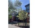 Well-maintained condo building featuring lush trees and landscaping at 1438 Little Raven St # 306, Denver, CO 80202
