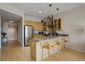 Bright kitchen featuring stainless steel appliances, granite countertops, and a convenient breakfast bar at 1438 Little Raven St # 306, Denver, CO 80202