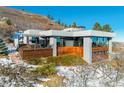 Contemporary home with wood siding and expansive windows at 5401 Antler Run, Littleton, CO 80125