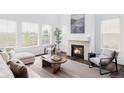 Bright living room with fireplace, hardwood floors, modern furniture, and large windows with views at 740 Meadowlark Dr, Erie, CO 80516
