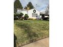 Charming home featuring a well-manicured front yard with trees and a welcoming wreath on the facade at 4780 Milwaukee St, Denver, CO 80216