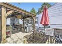 Backyard patio featuring an outdoor seating area with a grill and umbrella at 4780 Milwaukee St, Denver, CO 80216