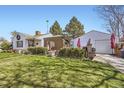 Landscaped backyard featuring a gazebo, patio, and detached garage at 4780 Milwaukee St, Denver, CO 80216