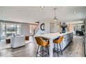 Modern kitchen with marble countertops, stainless steel appliances, and seating at the island at 14223 W 1St Dr, Golden, CO 80401