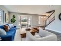 Inviting living room features hardwood floors, a bay window, and a staircase at 14223 W 1St Dr, Golden, CO 80401