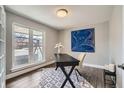 Bright home office with a modern desk, hardwood floors, and a large window view at 14223 W 1St Dr, Golden, CO 80401