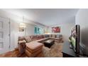Cozy living room featuring a large sectional sofa, ottoman, and TV at 663 S Xenon Ct, Lakewood, CO 80228