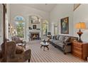 Cozy living room with fireplace, large windows, and comfortable seating arrangement at 24768 Foothills N Dr, Golden, CO 80401