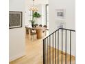 Open-concept dining area with hardwood floors and stylish decor, adjacent to the stairway at 1921 W 37Th Ave, Denver, CO 80211