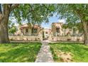 Inviting exterior view of the property featuring a well-manicured lawn and gated entrance at 485 S Logan St # 10, Denver, CO 80209