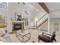 Bright living room featuring high ceilings, wood floors, with modern fireplace at 2363 Ranch Dr, Westminster, CO 80234