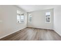 Bright living room with hardwood floors and neutral walls at 676 Apex Rise St, Erie, CO 80516