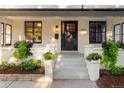 Inviting front porch with black door, white trim and beautiful landscaping details at 1815 S Ogden St, Denver, CO 80210