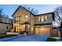 Stunning two-story home with a brick exterior and a modern, light wood garage door at 355 Forest St, Denver, CO 80220