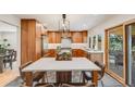 Bright kitchen features a breakfast bar island, modern lighting, and stainless steel appliances at 2773 S Macon St, Aurora, CO 80014