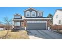 Charming two-story home with a well-maintained front yard and attached two-car garage at 10286 Rotherwood Cir, Highlands Ranch, CO 80130