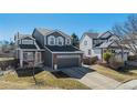 Charming two-story home with a well-maintained front yard and attached two-car garage at 10286 Rotherwood Cir, Highlands Ranch, CO 80130