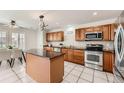 Well-lit kitchen featuring granite countertops, tile flooring, and stainless steel appliances at 5957 Turnstone Pl, Castle Rock, CO 80104