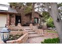 Charming brick home featuring a well-maintained lawn, brick staircase, and mature landscaping at 5531 S Telluride Ct, Centennial, CO 80015