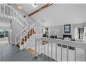 Bright, open-concept living area with vaulted ceilings, a fireplace, and a staircase at 5531 S Telluride Ct, Centennial, CO 80015
