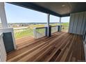 Wide balcony with wood floors and railing, providing stunning views of the surrounding landscape at 8326 Cokedale Cir, Littleton, CO 80125