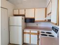 Practical kitchen layout with a refrigerator, microwave, and essential appliances at 4760 S Wadsworth # 301, Littleton, CO 80123