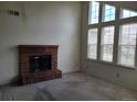 Bright living room with a brick fireplace and large windows offering plenty of natural light at 4760 S Wadsworth # 301, Littleton, CO 80123