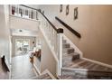Inviting foyer features an open staircase and flows into the living spaces at 7450 W Coal Mine Ave # D, Littleton, CO 80123