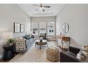 Bright living room with a plush sofa, high ceilings, and lots of natural light at 8784 S Riviera Ct, Aurora, CO 80016