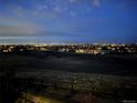 An amazing night view of illuminated cityscape with a community of houses at dusk at 8784 S Riviera Ct, Aurora, CO 80016