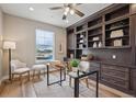 Comfortable office with a large window, hardwood floors and built-in shelves at 8784 S Riviera Ct, Aurora, CO 80016
