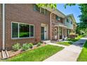 Charming brick townhome with a well-manicured lawn and sidewalk at 3806 S Yosemite St, Denver, CO 80237