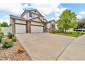 Charming two-story home with a three-car garage, stone accents, and well-manicured front yard at 5286 Rustic Ave, Firestone, CO 80504